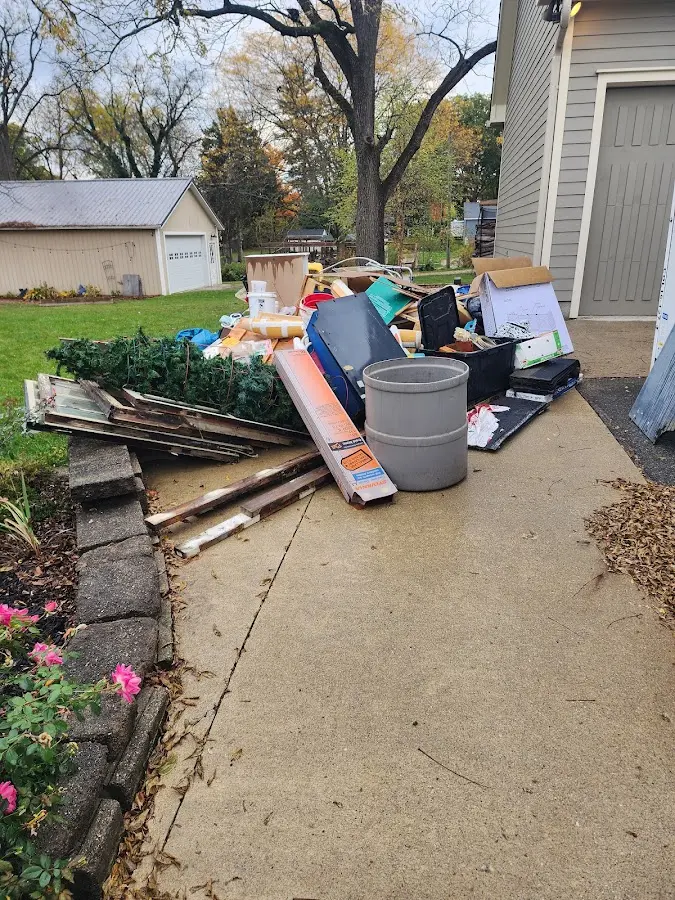 Dumpster being loaded with debris for Roofing Dumpster Rental in Wright